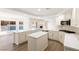 Bright, open kitchen boasts a large island, stainless appliances, and views of the pool at 3021 Ocean Port Dr, Las Vegas, NV 89117
