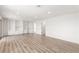 Large living room with built-in white shelves, recessed lighting, and wood floors at 3021 Ocean Port Dr, Las Vegas, NV 89117