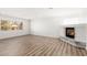 Spacious living room with fireplace, natural light, and modern laminate flooring at 3021 Ocean Port Dr, Las Vegas, NV 89117