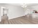 Large living room boasts hard wood floors, bright lighting, and modern chandelier at 3021 Ocean Port Dr, Las Vegas, NV 89117