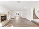 Bright living room boasts a fireplace, wood floors, archways and easy access to the staircase at 3021 Ocean Port Dr, Las Vegas, NV 89117