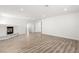 Spacious living room with fireplace, natural light, modern laminate flooring, and neutral color palette at 3021 Ocean Port Dr, Las Vegas, NV 89117