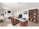 Bright office featuring a desk with a marble top, built-in white shelves, and wood floors at 3021 Ocean Port Dr, Las Vegas, NV 89117