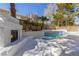 Backyard pool with fireplace, palm trees, and privacy wall at 3021 Ocean Port Dr, Las Vegas, NV 89117