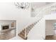 Open staircase bathed in natural light, featuring a contemporary chandelier and minimalist design at 3021 Ocean Port Dr, Las Vegas, NV 89117