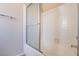 Bathroom features a shower-tub combo with white tiling and sliding glass door at 3125 Cristobal Way, Las Vegas, NV 89117