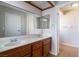 Bathroom with double sinks, large mirrors, and white walls at 3125 Cristobal Way, Las Vegas, NV 89117