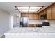 Bright kitchen features light cabinets, tile countertops, and natural lighting at 3125 Cristobal Way, Las Vegas, NV 89117