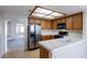Bright kitchen with stainless steel refrigerator and tile countertops at 3125 Cristobal Way, Las Vegas, NV 89117
