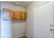 Functional laundry area with wooden cabinets, connections for washer/dryer, and access to a door at 3125 Cristobal Way, Las Vegas, NV 89117