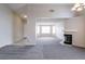 Open-concept living area with neutral carpet, fireplace, and abundant natural light at 3125 Cristobal Way, Las Vegas, NV 89117