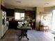 Well-lit kitchen featuring tile floors, dark wood cabinets, and white appliances at 3601 Pinnate Dr, Las Vegas, NV 89147