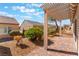 Back patio featuring a pergola, paving stones, desert landscaping and views of neighboring houses at 3603 Herring Gull Ln, North Las Vegas, NV 89084