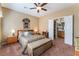 Bedroom with a large bed, ceiling fan, and access to the bathroom at 3603 Herring Gull Ln, North Las Vegas, NV 89084