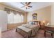 Bedroom with a large bed, ceiling fan, and a writing desk at 3603 Herring Gull Ln, North Las Vegas, NV 89084