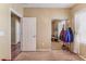 Neutral bedroom featuring mirrored closet doors, carpet flooring, window with curtains and coat rack at 3603 Herring Gull Ln, North Las Vegas, NV 89084