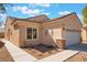 Well-maintained home with a two-car garage, desert landscaping, and stucco exterior at 3603 Herring Gull Ln, North Las Vegas, NV 89084