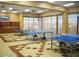 Spacious game room with multiple ping pong tables, built-in storage, and large windows at 3603 Herring Gull Ln, North Las Vegas, NV 89084