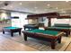 Spacious game room features multiple billiard tables with overhead lighting and seating area at 3603 Herring Gull Ln, North Las Vegas, NV 89084