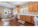 Bright eat-in kitchen with wood floors, white countertops, and ample cabinet space at 3603 Herring Gull Ln, North Las Vegas, NV 89084