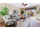 Comfortable living room with plush seating, wood floors, and natural light from sliding doors at 3603 Herring Gull Ln, North Las Vegas, NV 89084