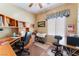Functional office space with two desks, shelving units, and natural light from the window at 3603 Herring Gull Ln, North Las Vegas, NV 89084