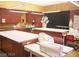 A work room featuring cabinets, storage, work tables, sewing machines, and ironing board setup at 3603 Herring Gull Ln, North Las Vegas, NV 89084