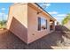 Backyard view with desert landscaping, gravel, and a partial view of a covered patio at 3608 Herring Gull Ln, North Las Vegas, NV 89084