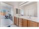 Bathroom with double sink vanity and view into an adjacent bedroom at 3608 Herring Gull Ln, North Las Vegas, NV 89084
