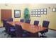 A conference room offers an extensive table, seating for ten, and walls decorated with various certificates at 3608 Herring Gull Ln, North Las Vegas, NV 89084
