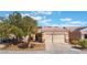 Charming single-story home with a two-car garage, desert landscaping, and a tile roof at 3608 Herring Gull Ln, North Las Vegas, NV 89084