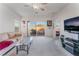 Cozy living area with natural light, ceiling fan, and sliding glass doors leading to the outdoors at 3608 Herring Gull Ln, North Las Vegas, NV 89084