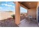 Covered patio featuring a table and chairs with gravel landscaping at 3608 Herring Gull Ln, North Las Vegas, NV 89084