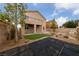 The backyard offers synthetic turf, mature trees, and a rock feature at 3718 True Spring Pl, North Las Vegas, NV 89032
