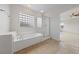 Large tub and shower with glass enclosure with tile surround at 3718 True Spring Pl, North Las Vegas, NV 89032