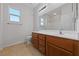 Bathroom with a wide wood vanity and large mirror with bright lighting at 3718 True Spring Pl, North Las Vegas, NV 89032