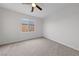 Bright bedroom with neutral carpet, fan, and large window offering views at 3718 True Spring Pl, North Las Vegas, NV 89032