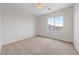 This cozy bedroom offers neutral carpet, a ceiling fan, and a bright window at 3718 True Spring Pl, North Las Vegas, NV 89032