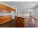 Open concept kitchen features wood cabinets, granite countertops, and dark wood floors at 3718 True Spring Pl, North Las Vegas, NV 89032