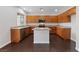 Well-appointed kitchen featuring an island, wood cabinets, and modern appliances at 3718 True Spring Pl, North Las Vegas, NV 89032