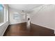 Open-concept living area featuring wood floors, a staircase, and bright windows at 3718 True Spring Pl, North Las Vegas, NV 89032