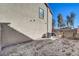 View of the backyard featuring a beige wall, AC unit, and wooden fence at 4225 Ponce Royal Ave, North Las Vegas, NV 89031