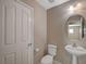 Cozy half-bath featuring pedestal sink and neutral colors at 4225 Ponce Royal Ave, North Las Vegas, NV 89031