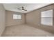 Spacious bedroom with neutral carpet, bright windows, and ceiling fan at 4225 Ponce Royal Ave, North Las Vegas, NV 89031