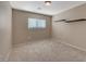 Empty bedroom with carpeted floors, window, and two floating shelves at 4225 Ponce Royal Ave, North Las Vegas, NV 89031