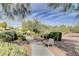 View of a neighborhood park with a stone path, park bench, and lush desert landscaping at 4225 Ponce Royal Ave, North Las Vegas, NV 89031