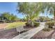 Neighborhood park featuring a park bench along a stone path, green lawn, and desert landscaping at 4225 Ponce Royal Ave, North Las Vegas, NV 89031