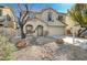 Inviting two-story home featuring desert landscaping, a spacious driveway, and an attached garage at 4225 Ponce Royal Ave, North Las Vegas, NV 89031