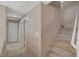 Hallway showcasing access to multiple rooms and a carpeted staircase at 4225 Ponce Royal Ave, North Las Vegas, NV 89031