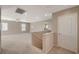 Bright, carpeted hallway with staircase, neutral walls, and ample lighting at 4225 Ponce Royal Ave, North Las Vegas, NV 89031